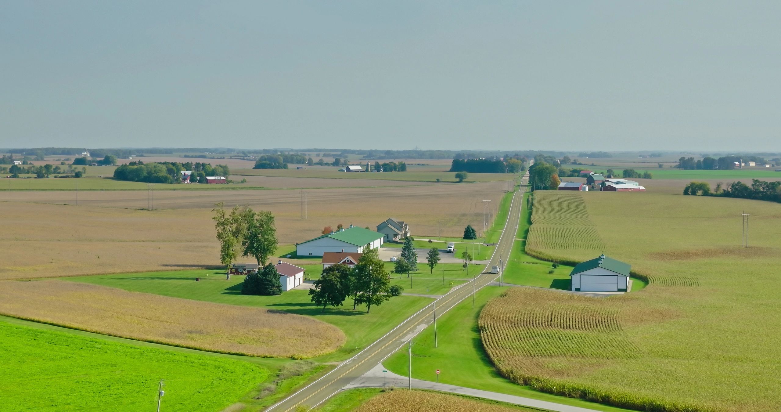 Farmland and country road evoking the rural heritage of Scroggs Farm